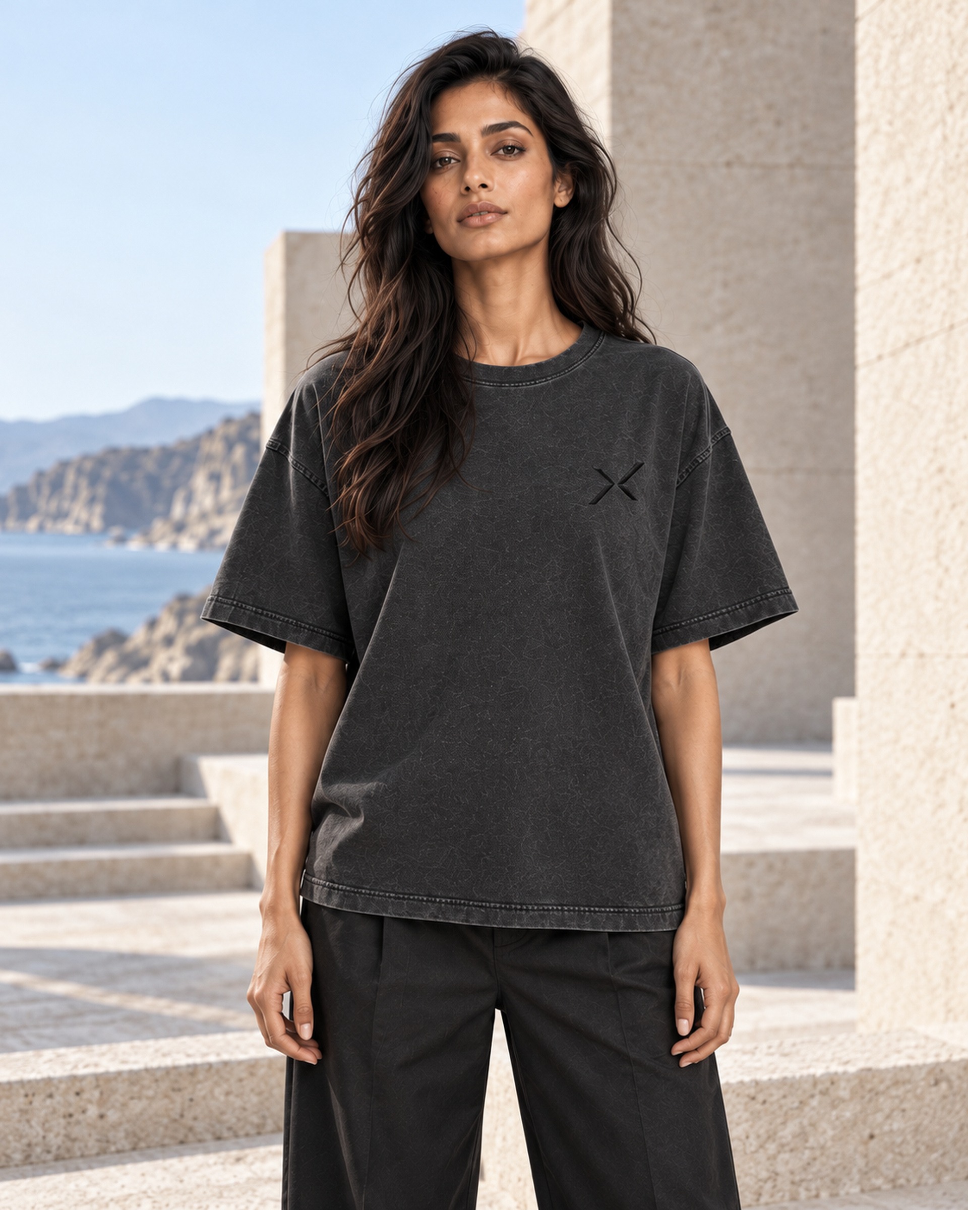 Adult wearer facing forward in NOCTURNE 01, showing the relaxed silhouette and dark chest signature.