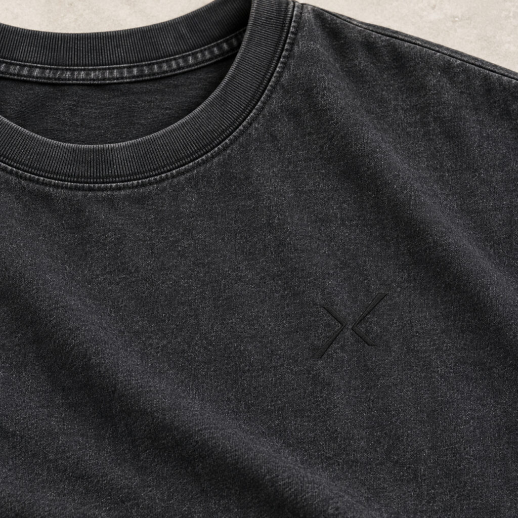 Close view of the ribbed collar, Washed Carbon texture and asymmetric dark chest signature.